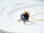 Handmade Galaxy Planet Resin Necklace with Gold Sun Charm - Image 5